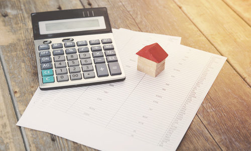 calculator and house on paper calculator and house on paper