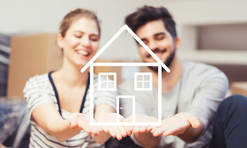 Young couple holding their new, dream home in hands Young couple holding their new, dream home in hands