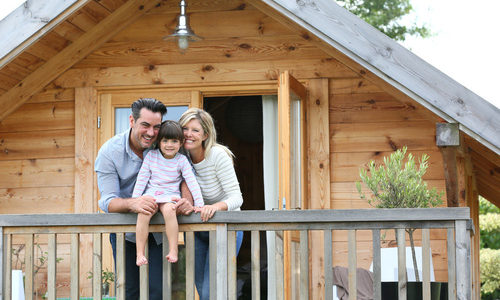 Family enjoying vacation in log cabin Family enjoying vacation in log cabin